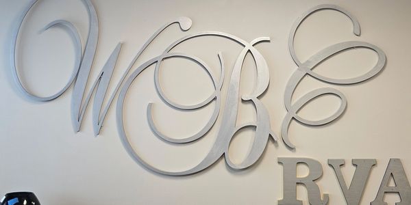 Curly metal letters mounted on a wall.