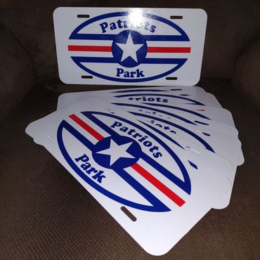 Stack of Patriots Park license plates with a blue star and red stripes.