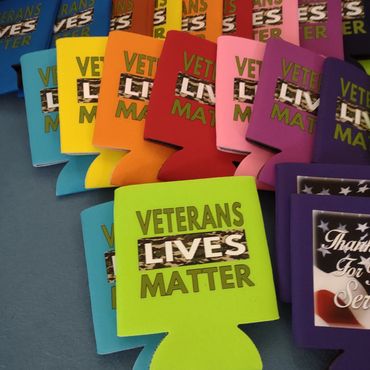 Colorful can coolers with "Veterans Lives Matter" message.