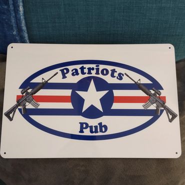 Sign reading 'Patriots Pub' with two rifles and a star logo.