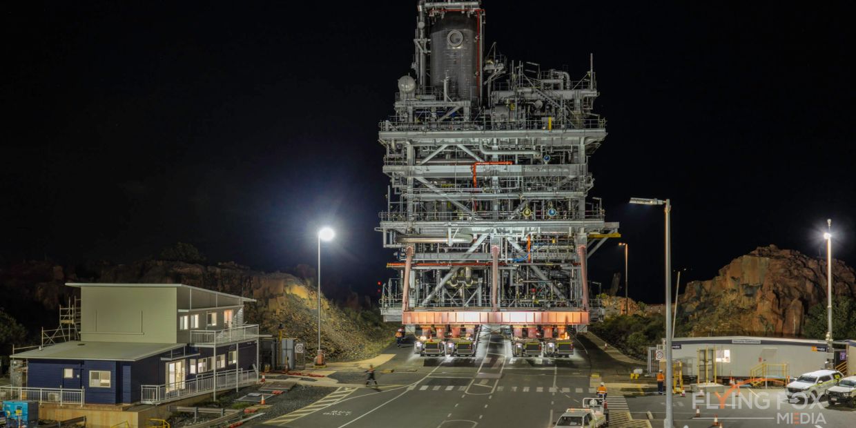 Large industrial structure being transported at night.