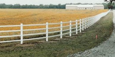 Omaha Fence Company with Round Rail Vinyl Fence.