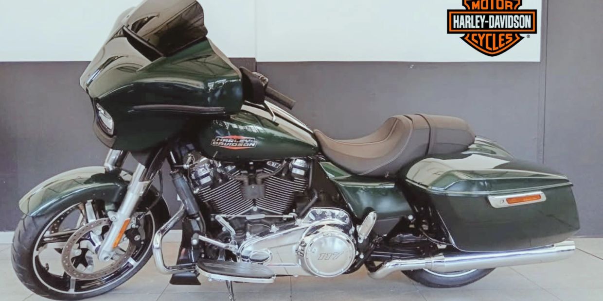 Sleek green Harley-Davidson motorcycle with saddlebags.