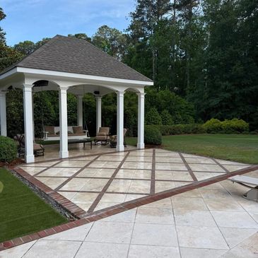 Elegant outdoor gazebo with tiled floor and greenery.