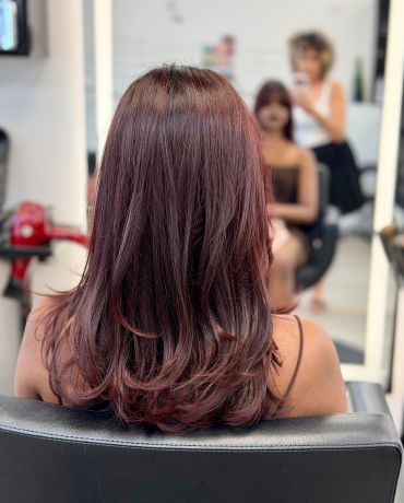 Freshly styled, shiny red hair in a salon.