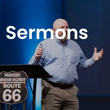 Man giving a sermon by a podium with Proverbs Route 66 sign.