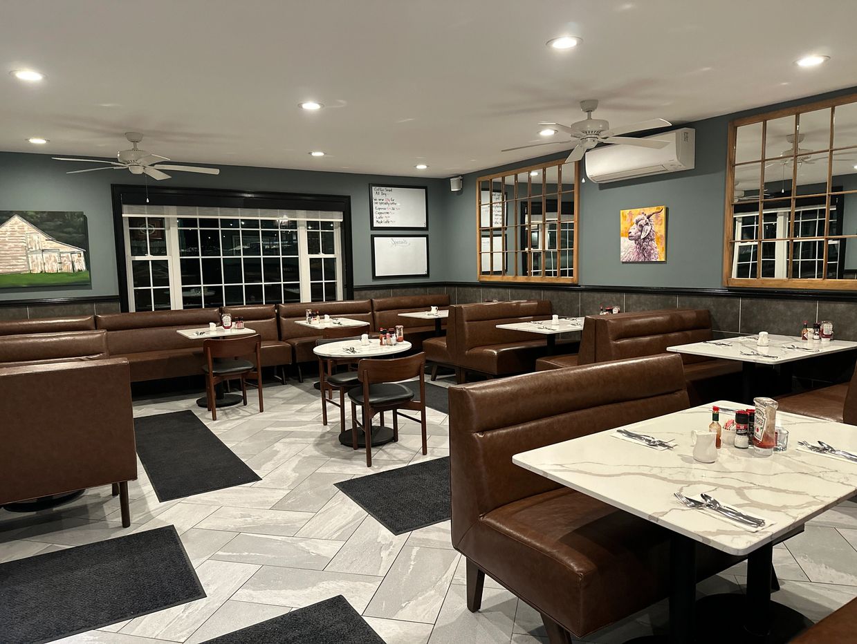 Inside view of hotel with table chair and ac