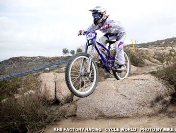 Mountain biker jumps over rocky terrain during a race.