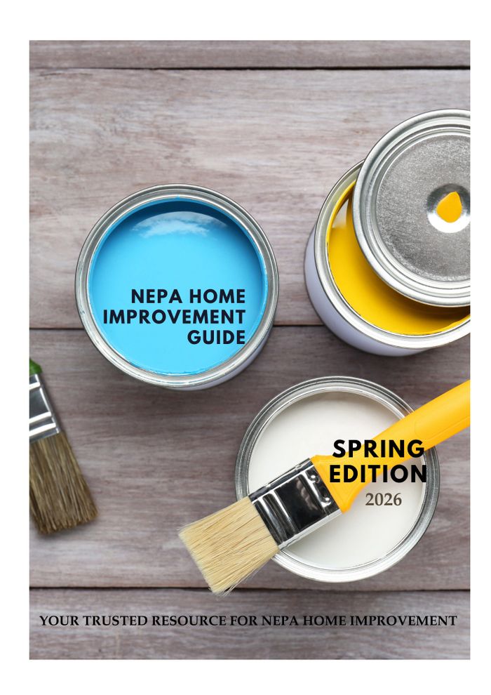 Stack of books next to pencils in a holder and a camera.