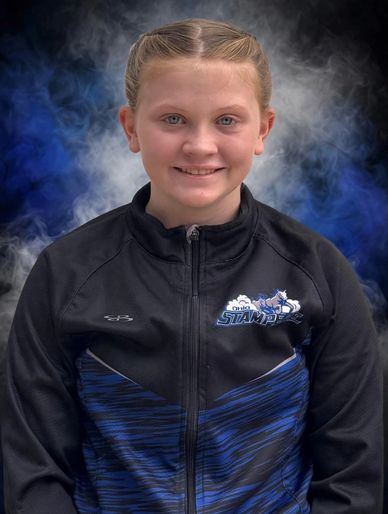 Smiling young girl in a sports jacket.
