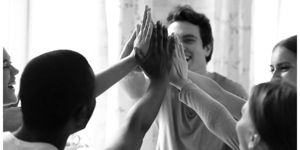 Group of people high-fiving one another