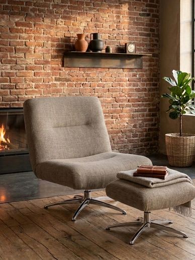 Cozy chair and ottoman by a fireplace in a rustic room.
