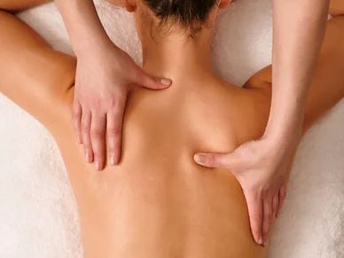 Person receiving a relaxing back massage with gentle hand pressure.