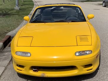 Bob Holman's 1992 Sunburst Yellow Miata Turbo, exterior front.