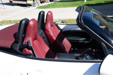 Convertible car interior with red seats.