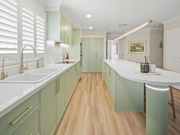Bespoke sage green custom kitchen design in Sydney with curved island bench and premium joinery.
