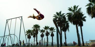 A fitness acrobat performing a stunt outdoor