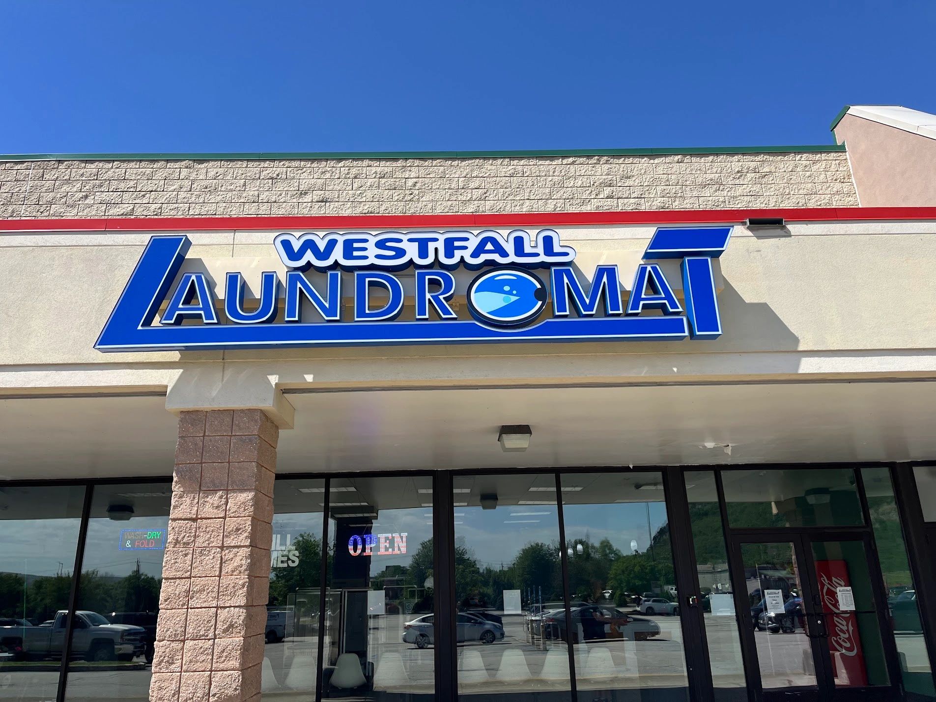 Sign for Westfall Laundromat on a sunny day.