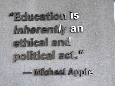 Quote about education by Michael Apple on a wall.