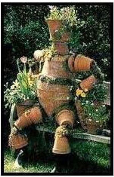 A statue made up of pots and plants