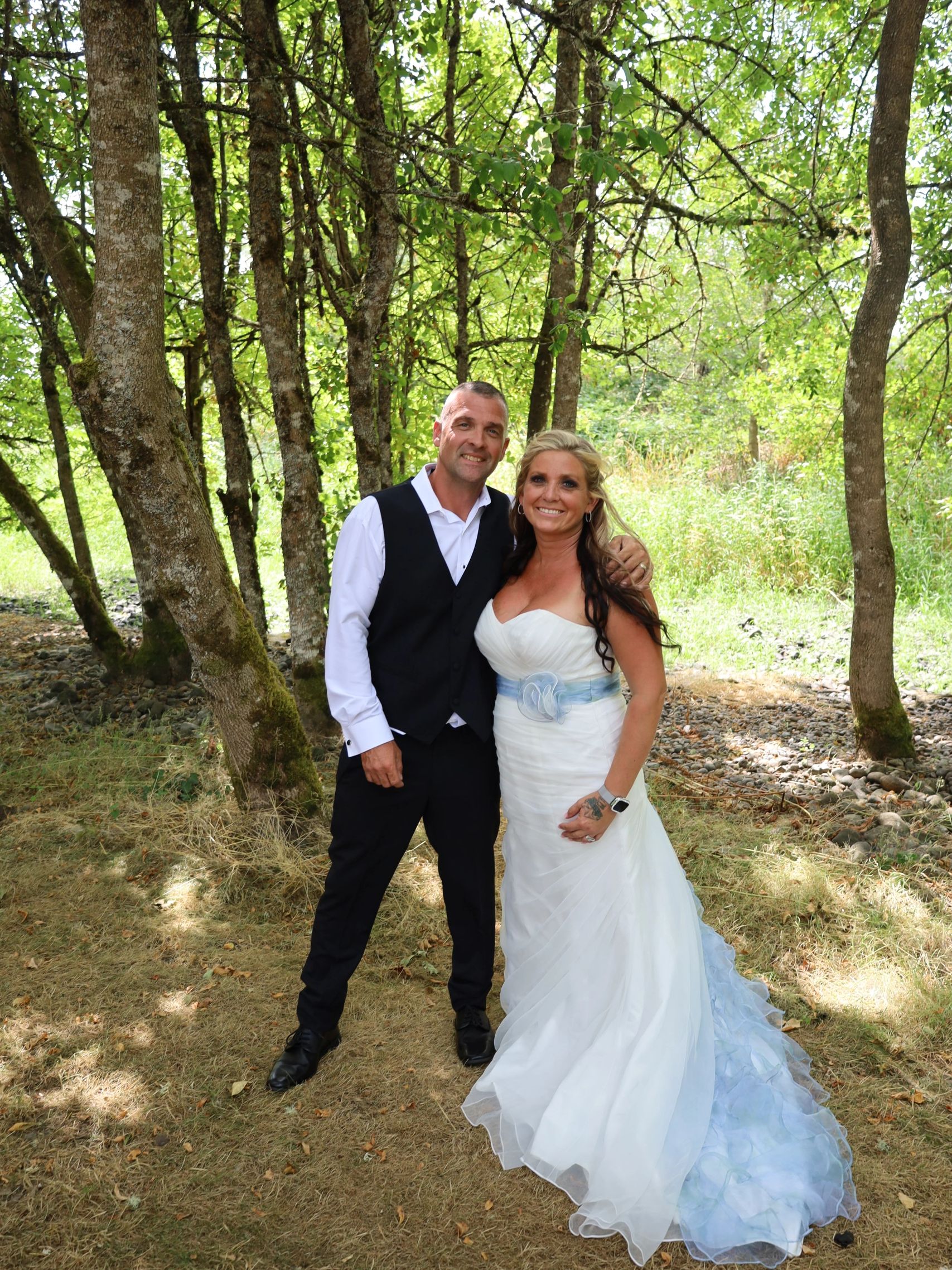 couple at creek of barn venue
