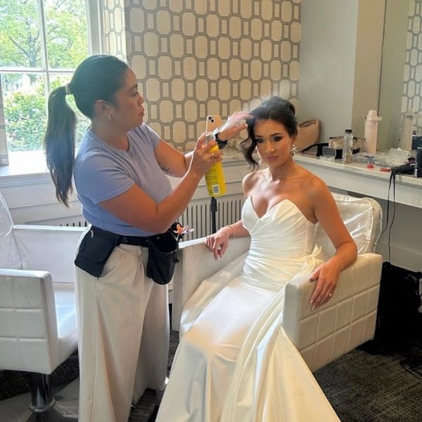 Bride getting her hair styled for the wedding.