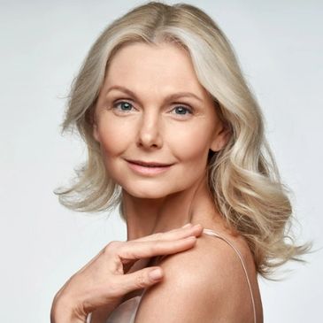 older blonde woman looking over her shoulder 