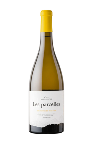 Bottle of Les parcelles white wine with a yellow cap and a white label.