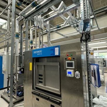 Industrial machine with pipes and control panel.
