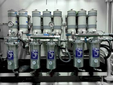 A complex industrial filtration system with multiple filters and gauges.