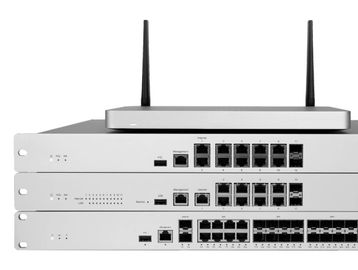 Stack of network switches with antennas on top.