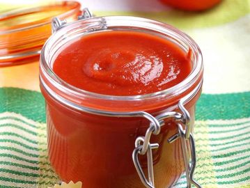 Jar filled with tomato sauce.