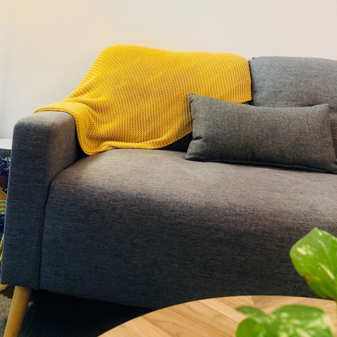 A welcoming counselling space with lush green plants and relaxing decor.