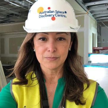 Jacqui wearing Australian Space Discovery Centre hard hat in building works