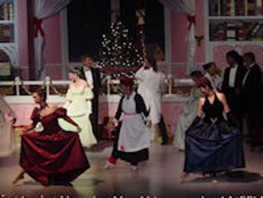 Actors performing a scene on stage in period costumes.