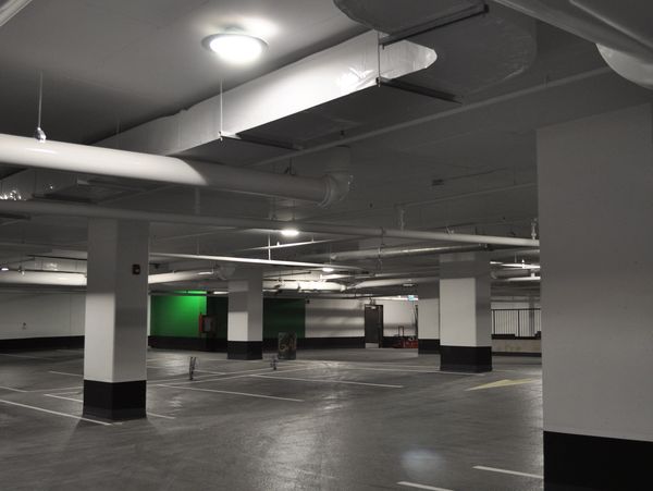 Empty indoor parking garage with white columns.