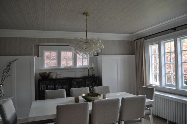 Elegant dining room with neutral tones and bubble chandelier.