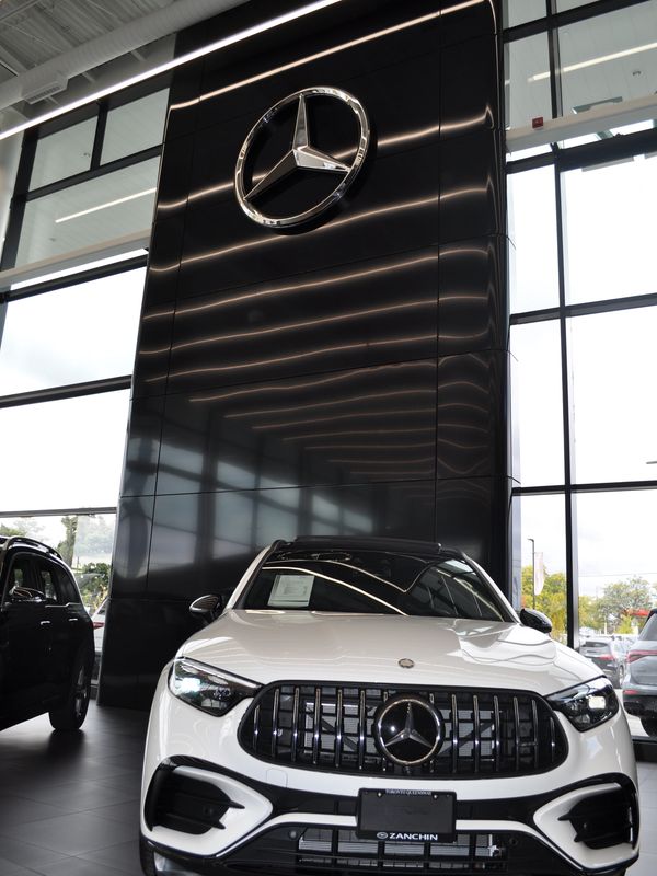 White Mercedes-Benz SUV inside a showroom.