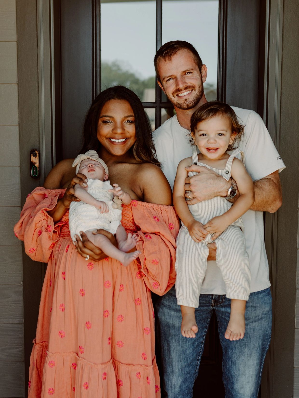 Austin Brooks, owner of DryTight Roofing, smiling with his wife Shakaira and their two children