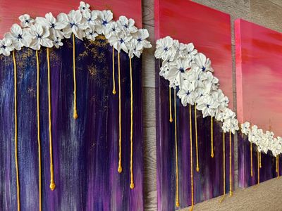 A three-panel artwork with white flowers and gold drips against pink and purple gradients.