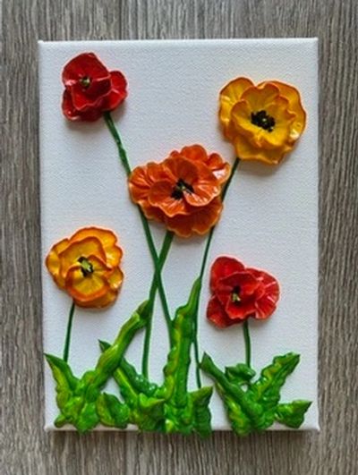A vibrant painting of red, orange, and yellow poppies with green stems on a white canvas.