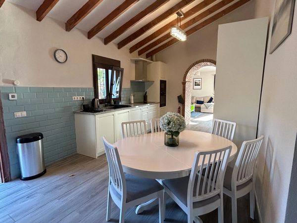 A kitchen with a round table and chairs