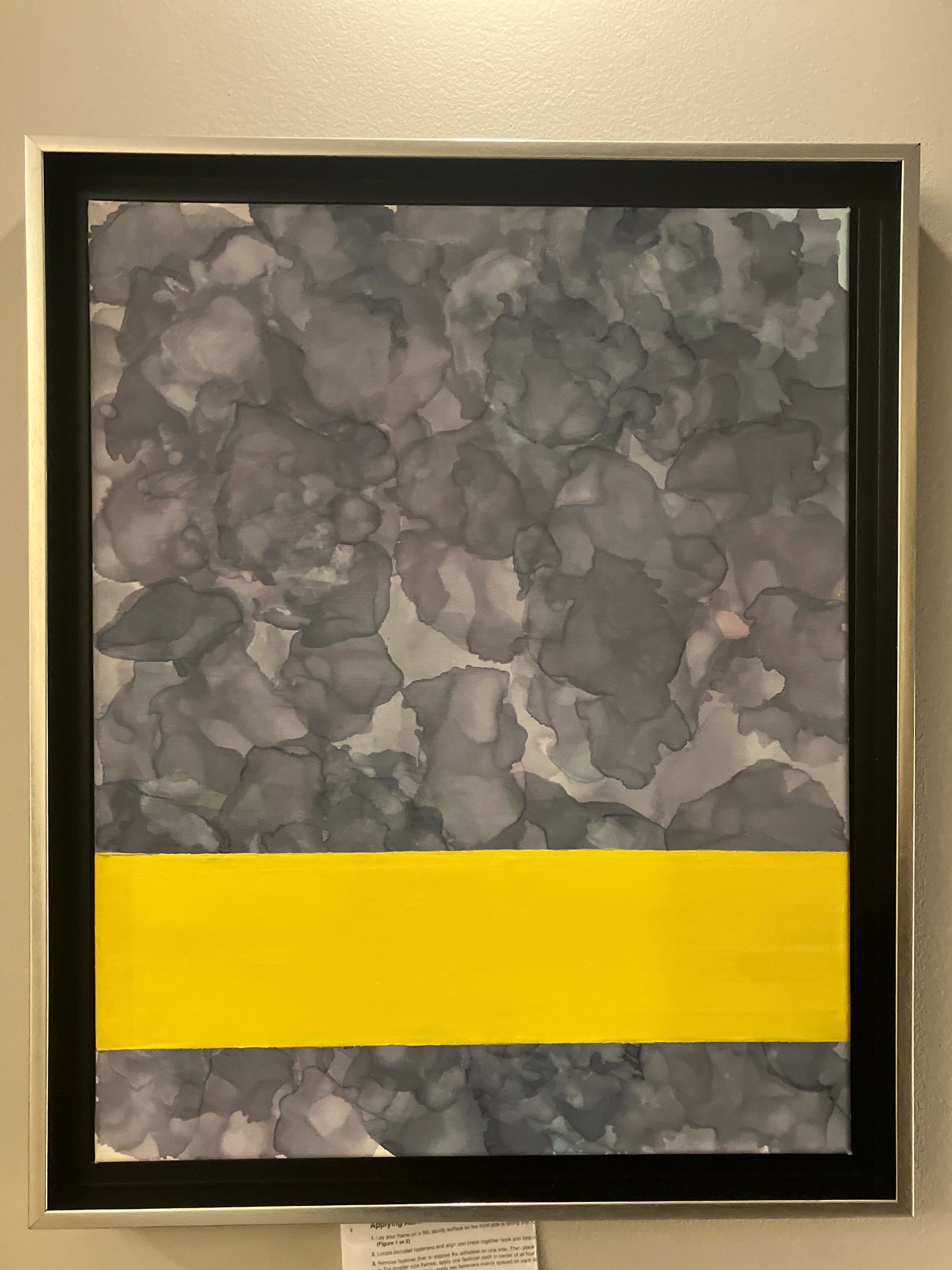 Abstract art with grey textures and a bold yellow horizontal stripe.