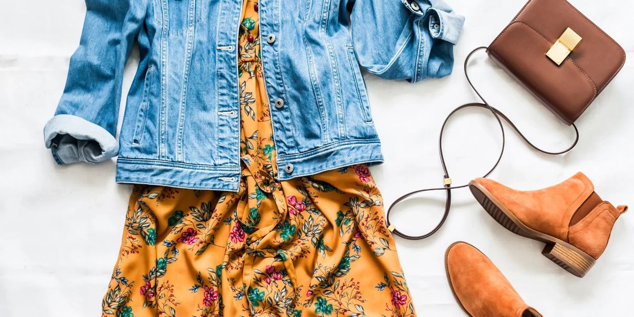 Casual outfit with denim jacket, floral dress, brown boots, and matching purse.