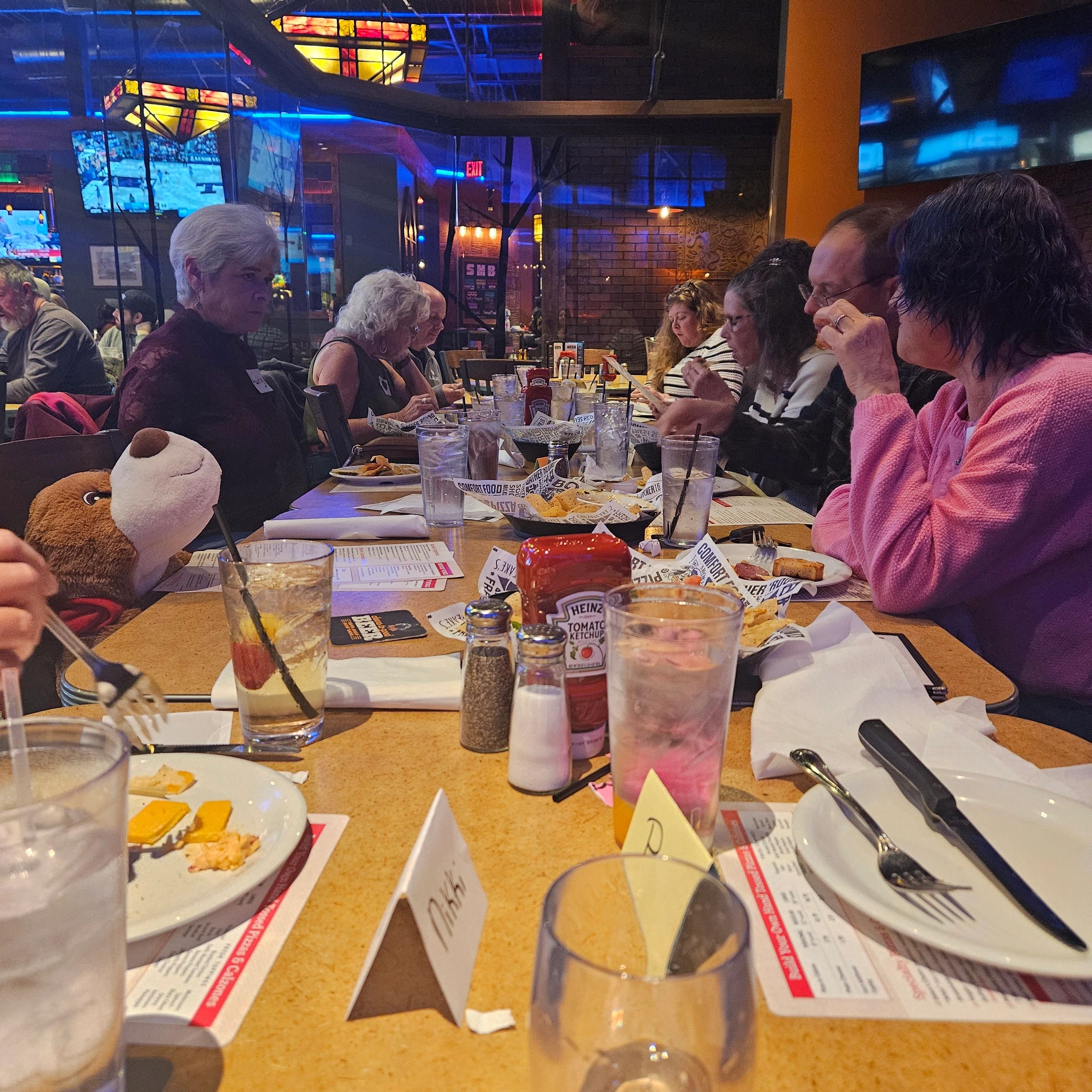 Group of elderly people dining together in a restaurant.