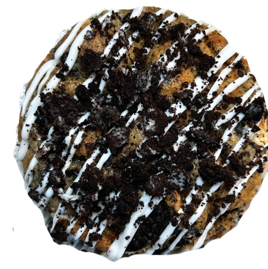 Cookies and cream dessert with white drizzle and cookie crumbles.