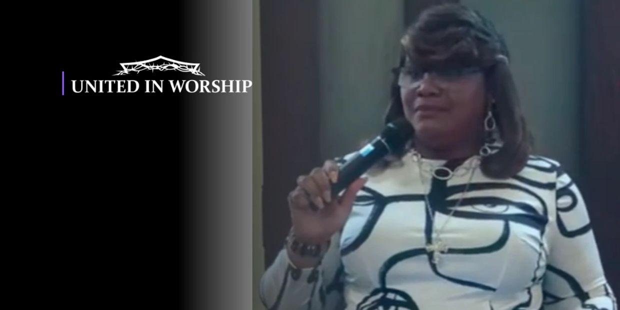 Woman speaking into microphone during a worship event.