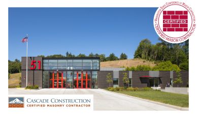 Modern commercial building with red accents and masonry certification.