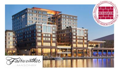 Modern waterfront building at dusk with masonry certification.