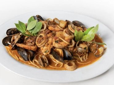 Cioppino Mediterraneo, fresh seafood with tomatoes over pasta